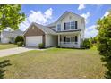 Attractive two-story home featuring a brick front, green lawn and inviting porch at 167 Decatur Dr, Summerville, SC 29486