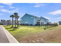 Spacious backyard with black fence, palm trees, and well-maintained lawn at 185 Whaler Ave, Summerville, SC 29486