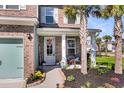 Inviting front porch with decorative wreath, cozy seating, and well-maintained landscaping at 185 Whaler Ave, Summerville, SC 29486