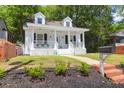 Charming white two-story home with a welcoming front porch and well-maintained lawn at 1920 Iris St, North Charleston, SC 29405