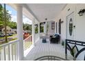 Charming front porch featuring white railings, columns, and comfortable outdoor furniture at 1920 Iris St, North Charleston, SC 29405