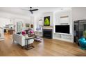 Bright living room featuring a fireplace, modern furnishings, and hardwood floors at 2229 Boatwright Rd, Johns Island, SC 29455