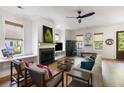 Elegant living room with a fireplace, cozy seating, and natural light from large windows at 2229 Boatwright Rd, Johns Island, SC 29455