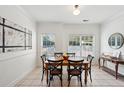 Bright dining area featuring hardwood table, black chairs, and a neutral color palette at 241 Howle Ave # F, Charleston, SC 29412