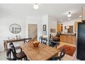Bright dining area featuring hardwood table, black chairs, and decorative wall art at 241 Howle Ave # F, Charleston, SC 29412