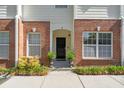 Close up of charming townhouse entrance with brick facade, and manicured landscaping at 241 Howle Ave # F, Charleston, SC 29412