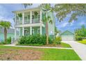 Two-story home with double porches, palm trees and a detached garage at 2596 Hatch Dr, Johns Island, SC 29455
