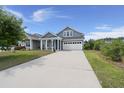 Charming blue two-story home with a well-manicured lawn and a two-car garage at 267 Palmetto Walk Dr, Summerville, SC 29486