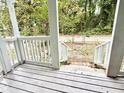 Covered porch with white railings and a view of a green and shady front yard at 307 Mill St, Walterboro, SC 29488