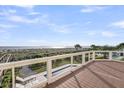Expansive wooden deck offering stunning ocean views and outdoor seating, perfect for relaxation at 3128 Palmetto Blvd, Edisto Island, SC 29438