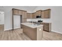 Well-equipped kitchen with wood cabinetry, granite countertops, stainless appliances and an island with a sink at 321 Abercom Place Dr, Moncks Corner, SC 29461