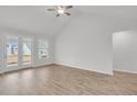 Bright living room featuring wood floors, a ceiling fan and direct access to the backyard through glass doors at 321 Abercom Place Dr, Moncks Corner, SC 29461