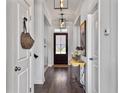 Inviting hallway with hardwood floors, stylish lighting, and neutral paint, providing a welcoming entrance at 3381 Stockdale St, Mount Pleasant, SC 29466