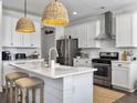 Bright kitchen with white cabinets, subway tile backsplash, stainless steel appliances, and a marble island at 3381 Stockdale St, Mount Pleasant, SC 29466