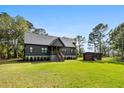 Charming single-Gathering home with a well-maintained lawn, shed, and inviting front porch at 3399 Freeman Hill Rd, Johns Island, SC 29455
