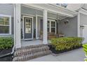 Welcoming front porch with hanging flower baskets, perfect for relaxing outdoors at 4019 Cascades Thrust, Summerville, SC 29483
