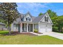 Charming two-story home featuring a well-manicured lawn, attached two car garage, and welcoming front porch at 402 Bay Creek Dr, Charleston, SC 29414