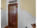 Inviting entryway featuring a wood door with adjustable blinds for privacy and natural light control at 41 Legare St # C, Charleston, SC 29401