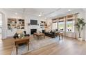 Bright living room features custom built-ins, coffered ceiling, fireplace and elegant decor at 4314 Grange Cir, Summerville, SC 29486