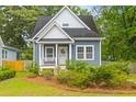 Inviting home exterior featuring a quaint front porch, manicured landscaping, and classic architectural details at 4524 Orr St, North Charleston, SC 29405