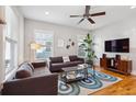 Bright living room features hardwood floors, neutral walls, stylish furniture, and ample natural light from windows at 4524 Orr St, North Charleston, SC 29405
