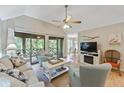 Inviting living room featuring hardwood floors, comfortable seating, and access to a screened porch at 4856 Green Dolphin Way # Share 7, Kiawah Island, SC 29455