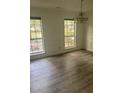Dining room features hardwood floors, two windows, and an attractive chandelier at 638 Leisure Ln, Mount Pleasant, SC 29464