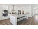 Open-concept kitchen with an island, stainless steel appliances, and sleek white cabinetry at 782 Clay Field Trl, Summerville, SC 29485