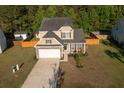 Two-story home boasting a manicured lawn, inviting curb appeal, and an attached garage on a sunny day at 8035 Mckayla Rd, Summerville, SC 29483