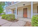 View of the front porch with white railings and trim around the front door at 8632 Madelyn St, North Charleston, SC 29406