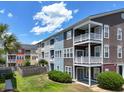 Townhouse exterior with balconies and well-maintained lawn and garden, perfect for outdoor relaxation at 9206 Southern Oak Ln, Ladson, SC 29456