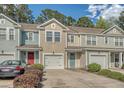 Charming townhomes featuring colorful exteriors, attached garages and well-maintained landscaping enhance curb appeal at 9418 Sweep Dr, Summerville, SC 29485