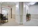 Hallway with patterned carpet, decorative trim, chair and table accents, and soft lighting at 1 Vendue Range # I, Charleston, SC 29401