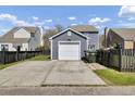 A detached one car garage at the rear of the property with a long concrete driveway and fenced in yard at 117 Red Leaf Blvd, Moncks Corner, SC 29461