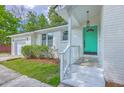 Welcoming white brick home featuring a bright teal front door and well-kept landscaping at 131 Ponderosa Dr, Ladson, SC 29456