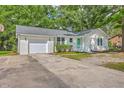 Inviting one-story home with white brick, attached garage, and well-maintained landscaping at 131 Ponderosa Dr, Ladson, SC 29456