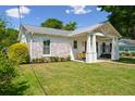 Charming home exterior features a porch swing and well-manicured lawn at 1474 Indian St, Mount Pleasant, SC 29464