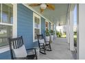 Inviting front porch with rocking chairs, ceiling fans, and decorative plants at 176 Clearblue Loop, Summerville, SC 29486
