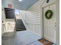 Hallway with stairs and unit entrance, featuring a wreath and light-colored walls at 2014 Basildon Rd, Mount Pleasant, SC 29466