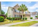 Inviting two-story home boasts stone accents, lush landscaping, and a well-manicured lawn at 2254 Show Basket Way, Mount Pleasant, SC 29466