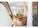 View of the Living Room from the foyer showcasing the hardwood floors and large bright windows at 2324 Town Woods Rd, Charleston, SC 29414