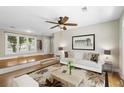 Cozy living room with hardwood floors, ceiling fan and large window at 2404 Menola Ave, Charleston, SC 29414