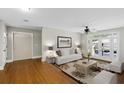 Bright living room features hardwood floors, ceiling fan and French doors to backyard at 2404 Menola Ave, Charleston, SC 29414