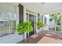 Charming front porch with potted ferns and a light-blue ceiling at 3101 S Shore Dr, Charleston, SC 29407