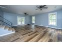 Bright living room with new floors, double doors, and stairs at 312 Piney Grove Rd, Cross, SC 29436