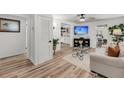 Bright living room features hardwood floors, a ceiling fan, and modern decor at 3293 River Rd, Johns Island, SC 29455