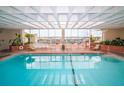 Inviting indoor swimming pool with lounge chairs, skylights, and access to an outdoor deck for relaxation at 330 Concord St # 2F, Charleston, SC 29401