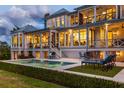 Beautiful outdoor space with a refreshing pool, comfortable lounge chairs, and covered patios for relaxing and entertaining at 332 Bayley Rd, Daniel Island, SC 29492