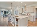 Bright kitchen showcases a large island with seating, pendant lighting, and stainless steel appliances at 3585 Sawlog Dr, Summerville, SC 29486