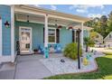 Inviting front porch featuring decorative elements, seating, and a colorful welcome sign at 3801 Canary Ct, North Charleston, SC 29420